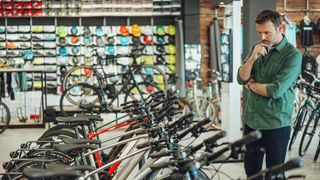 Man looking at bikes in a store