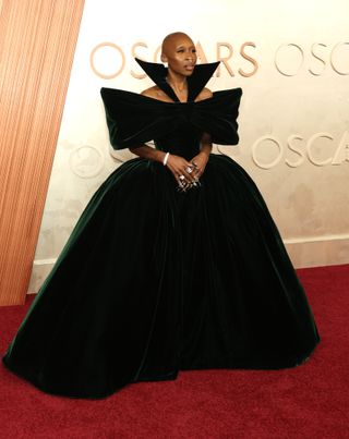 A photo of Cynthia Erivo paying homage to her Wicked character in a green velvet ballgown at the 2025 Oscars.