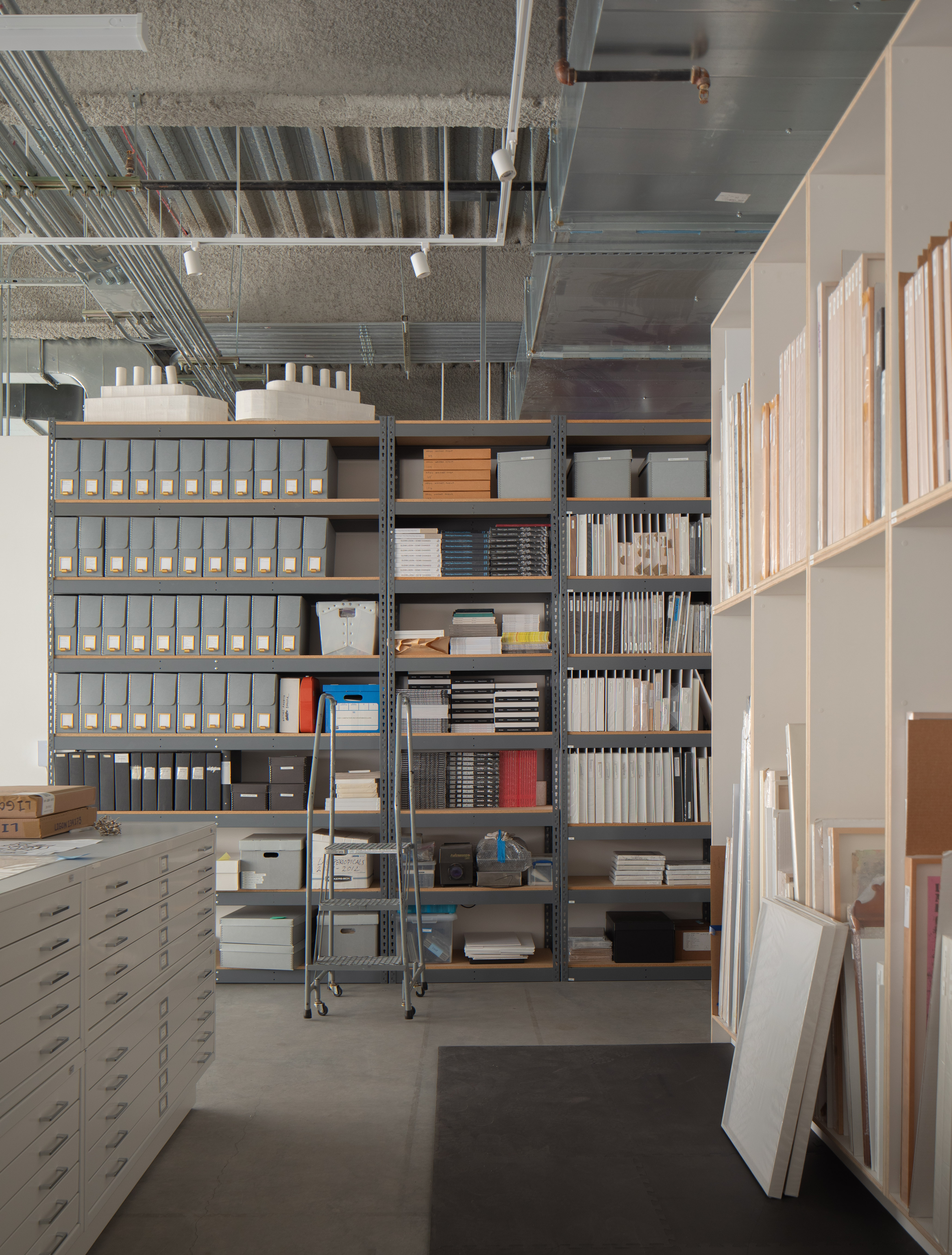 minimalist interior of artist Glenn Ligon's studio by Ravi Raj, with artworks and bespoke utilitarian furniture