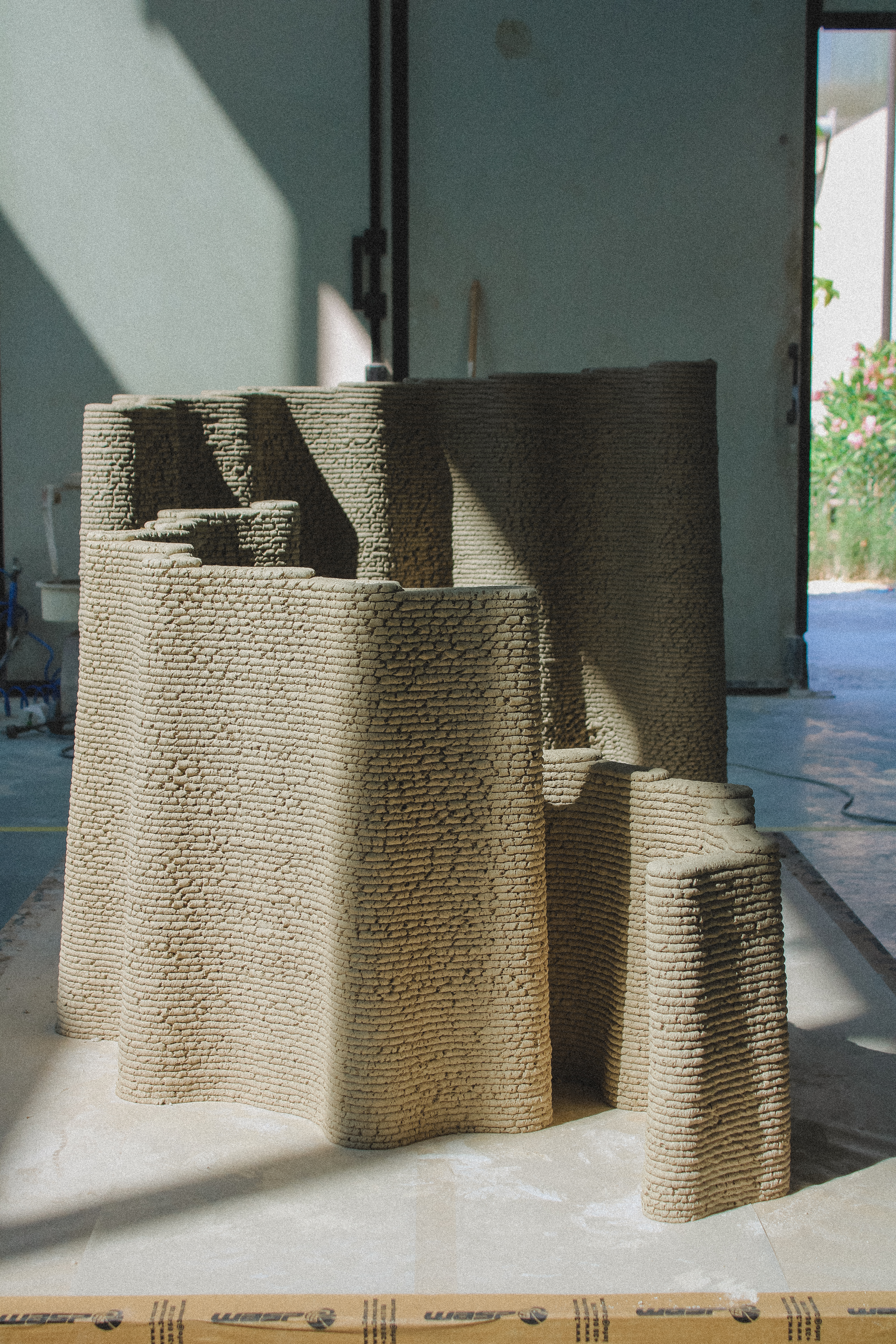 images of the production of Corncretl, a corn based bio alternative to concrete, which is 3D printed