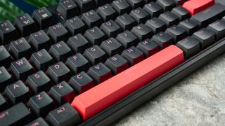 A black Lemokey X3 wired gaming keyboard with red keycaps