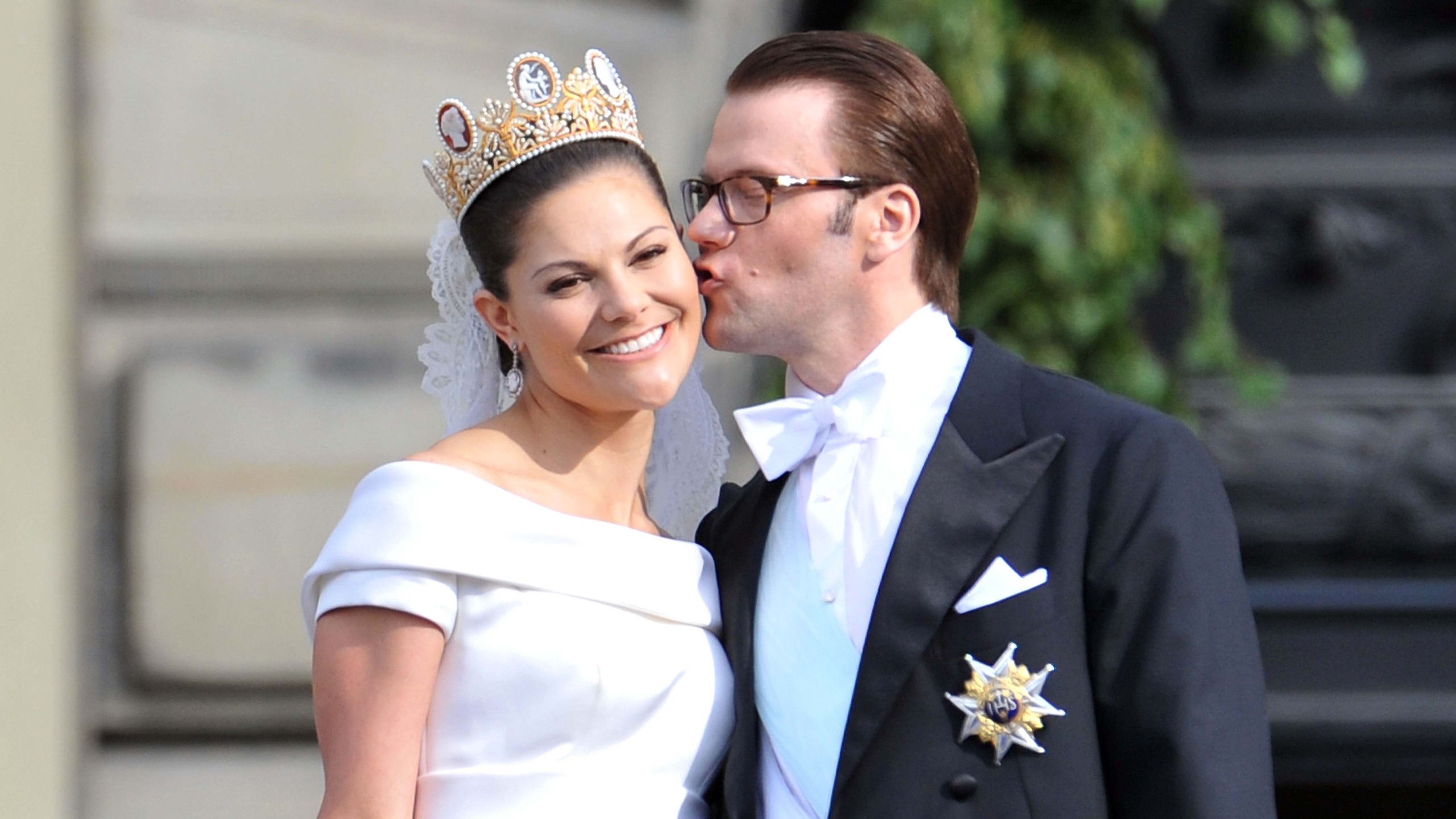 Prince Daniel, Duke of V&auml;sterg&ouml;tland kisses the cheek of Crown Princess Victoria of Sweden, Duchess of V&auml;sterg&ouml;tland on the Lejonbacken Terrace after their wedding ceremony
