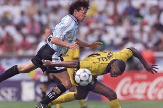 Argentina's Matias Almeyda competes for the ball with Jamaica's Darryl Powell at the 1998 World Cup.