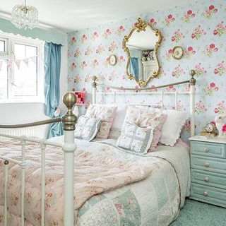 bedroom with floral wallpaper and bed