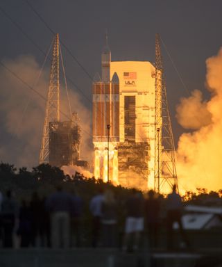 Spectators look on as a United Launch Alliance Delta IV Heavy rocket launches NASA's first Orion space capsule on an unmanned test flight from Cape Canaveral Air Force Station in Florida on Dec. 5, 2014.