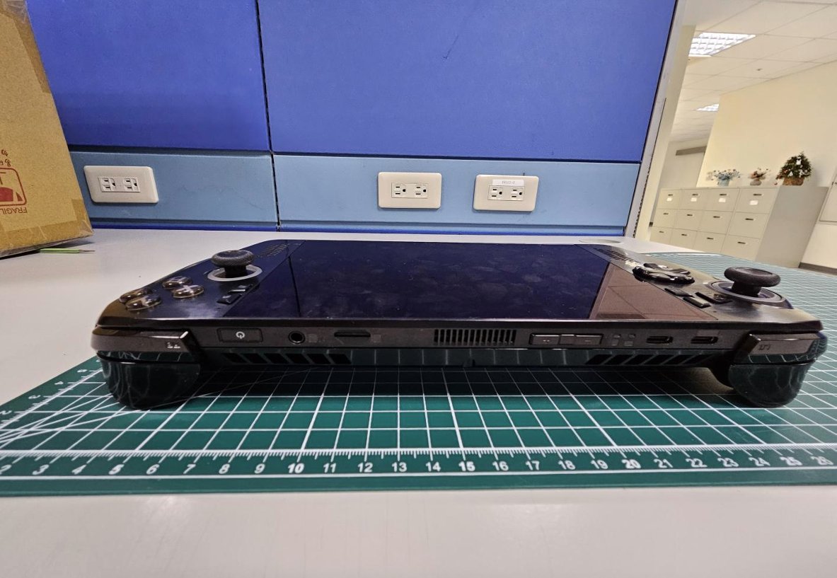 Photographs of an Asus ROG handheld gaming PC taken from FCC filings, showing the device's dimensions, new design, and button and port layout.