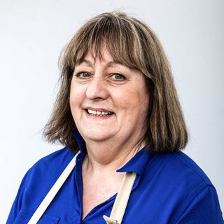 bake off contestant with blue top and apron