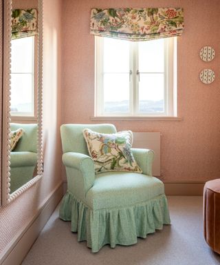 Pink bedroom with skirted occasional chair in Fermoie fabric