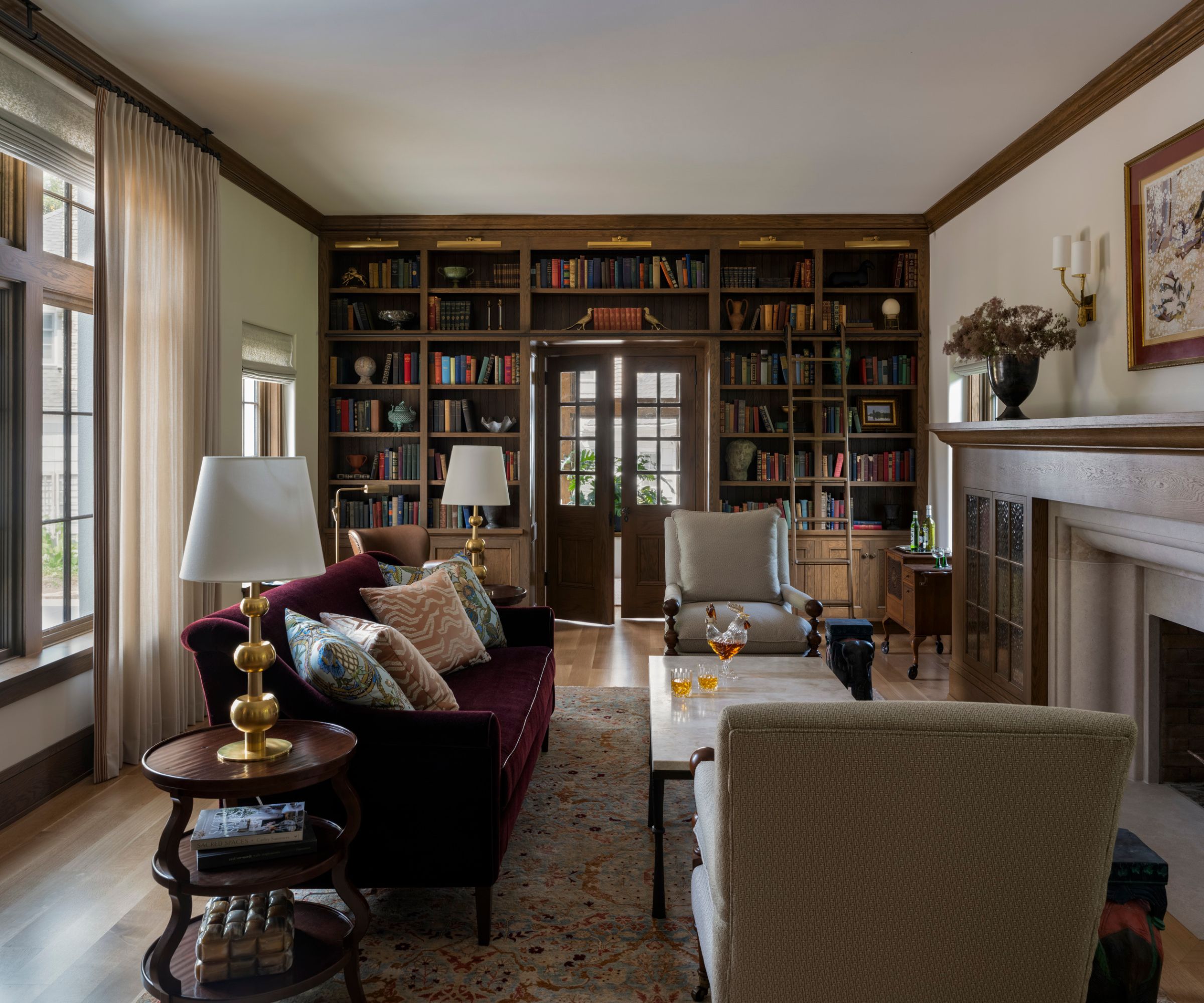 living room red sofa with built-in bookcases round fireplace