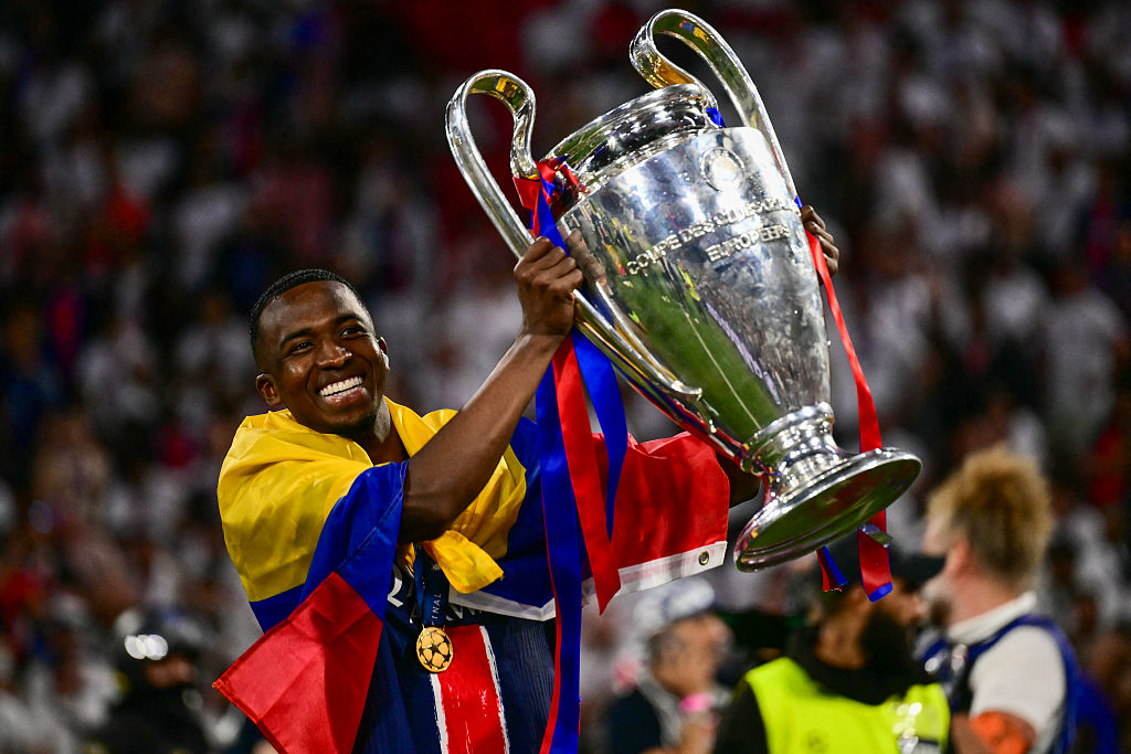 Paris Saint-Germain's Ecuadoran defender #51 Willian Pacho celebrates with the trophy after winning the UEFA Champions League final football match between Paris Saint-Germain (PSG) and Inter Milan in Munich, southern Germany on May 31, 2025.