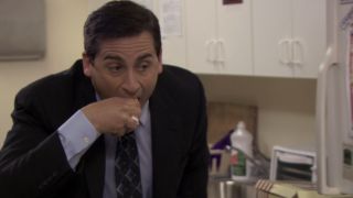 Michael taking a bit of cake from his hand in The Office