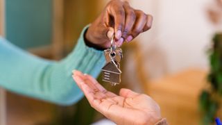 set of keys being handed over between two people