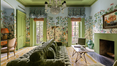beautiful, opulent living room with mural wallpaper, green ceiling and a fireplace