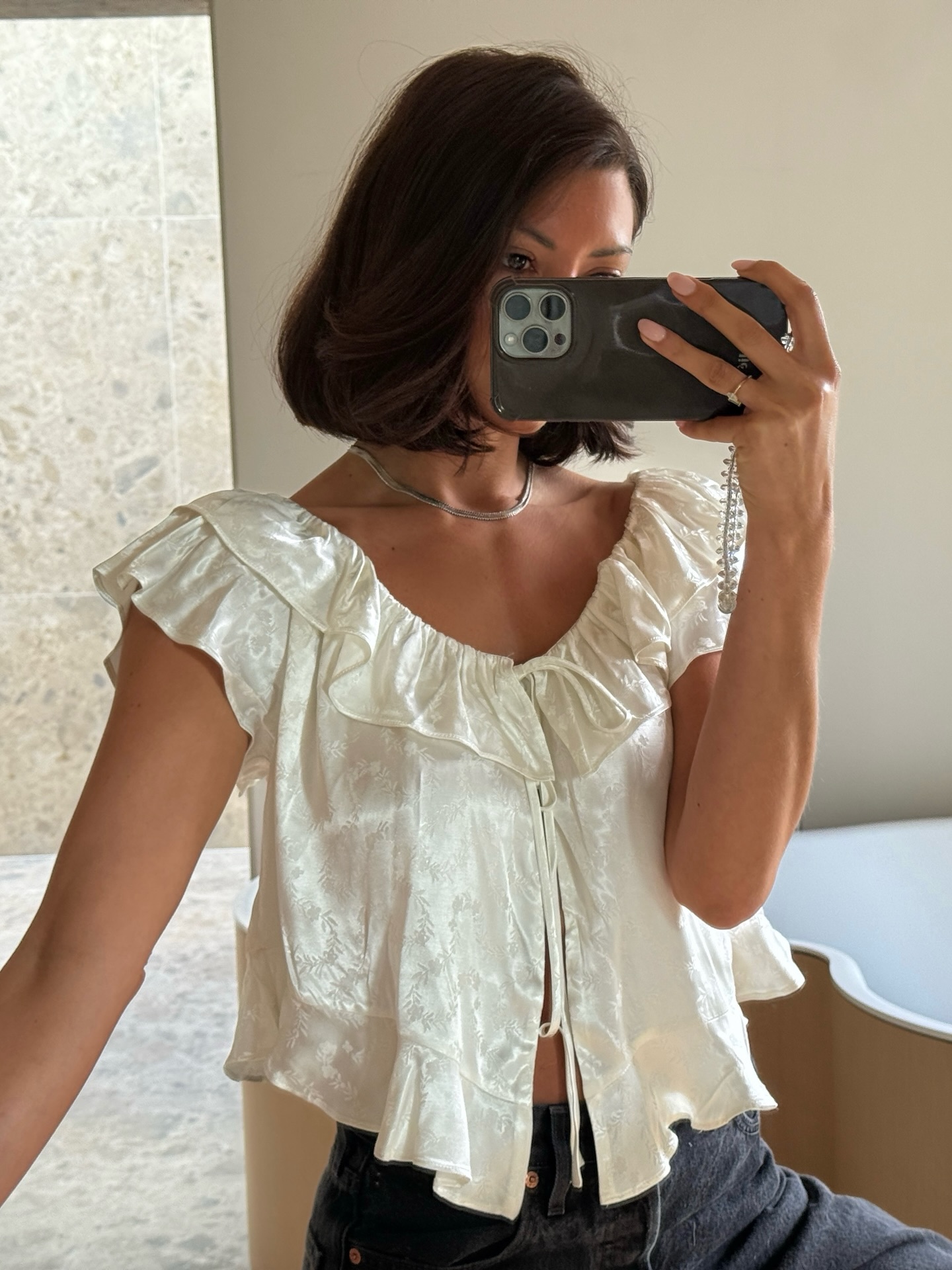 Marianne Smyth in a white silk D&amp;ocirc;en top.