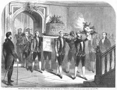 The 1857 Royal banquet at Windsor Castle at Christmas time, showing the procession of the dishes being carried in. The first is boar's head with parsley and traditional lemon in its month; the secondly is the large decorative Christmas pie.