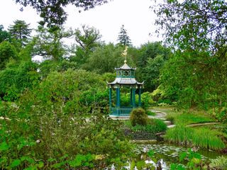 blue ornate pagoda in large garden