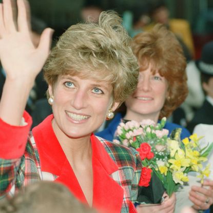 Princess Diana in a red and green blazer waving as her sister Sarah stands behind her