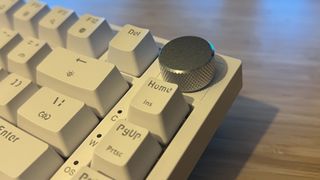 Close up on volume dial on Newmen GM326 gaming keyboard
