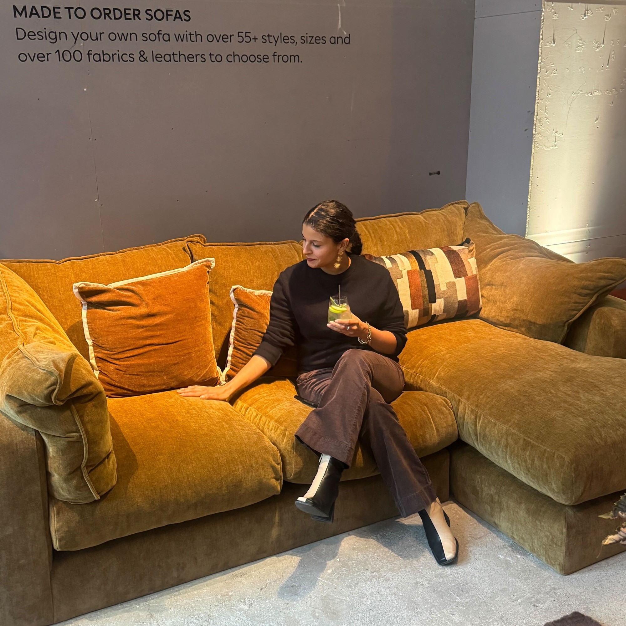Sara sitting on a chenille made-to-order chaise sofa at the Next autumn/winter 2025 press show