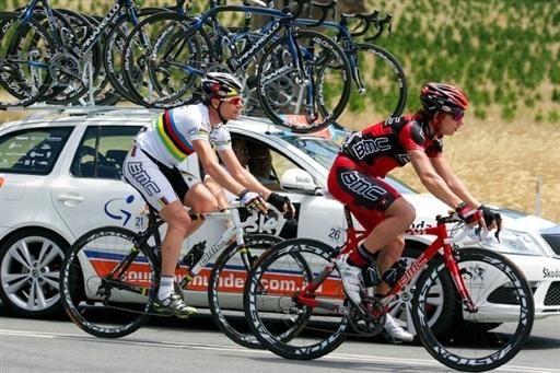 Cadel Evans goes back to the BMC team car with Mauro Santambrogio for help getting back on.