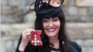 Hilary Devey receiving her CBE at Windsor Castle on 3 October 2013