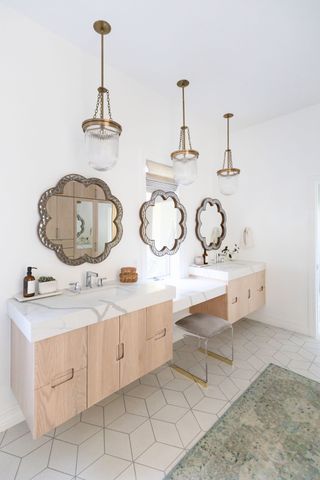 marble bathroom with double vanity and built-in makeup counter by Living with Lolo