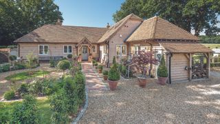 oak frame home with established front garden and gravel driveway