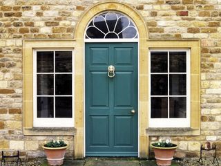 Lion headed knocker on dark green front door