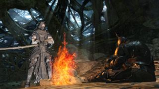 A screenshot from Dark Souls 2 of two figures by a bonfire.