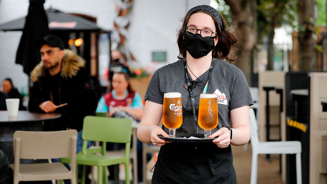 Pub barmaid with drinks 