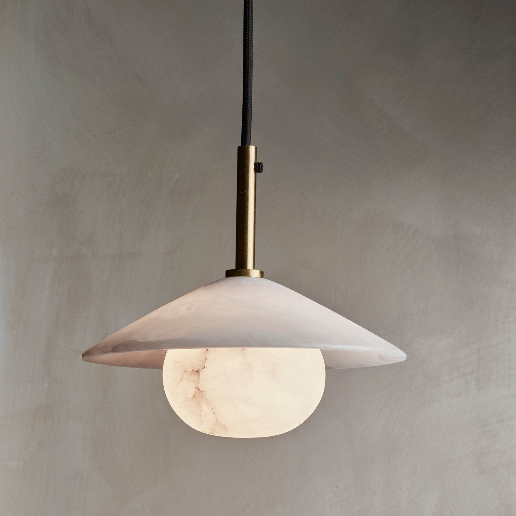 A grey marble look pendant light against a grey background