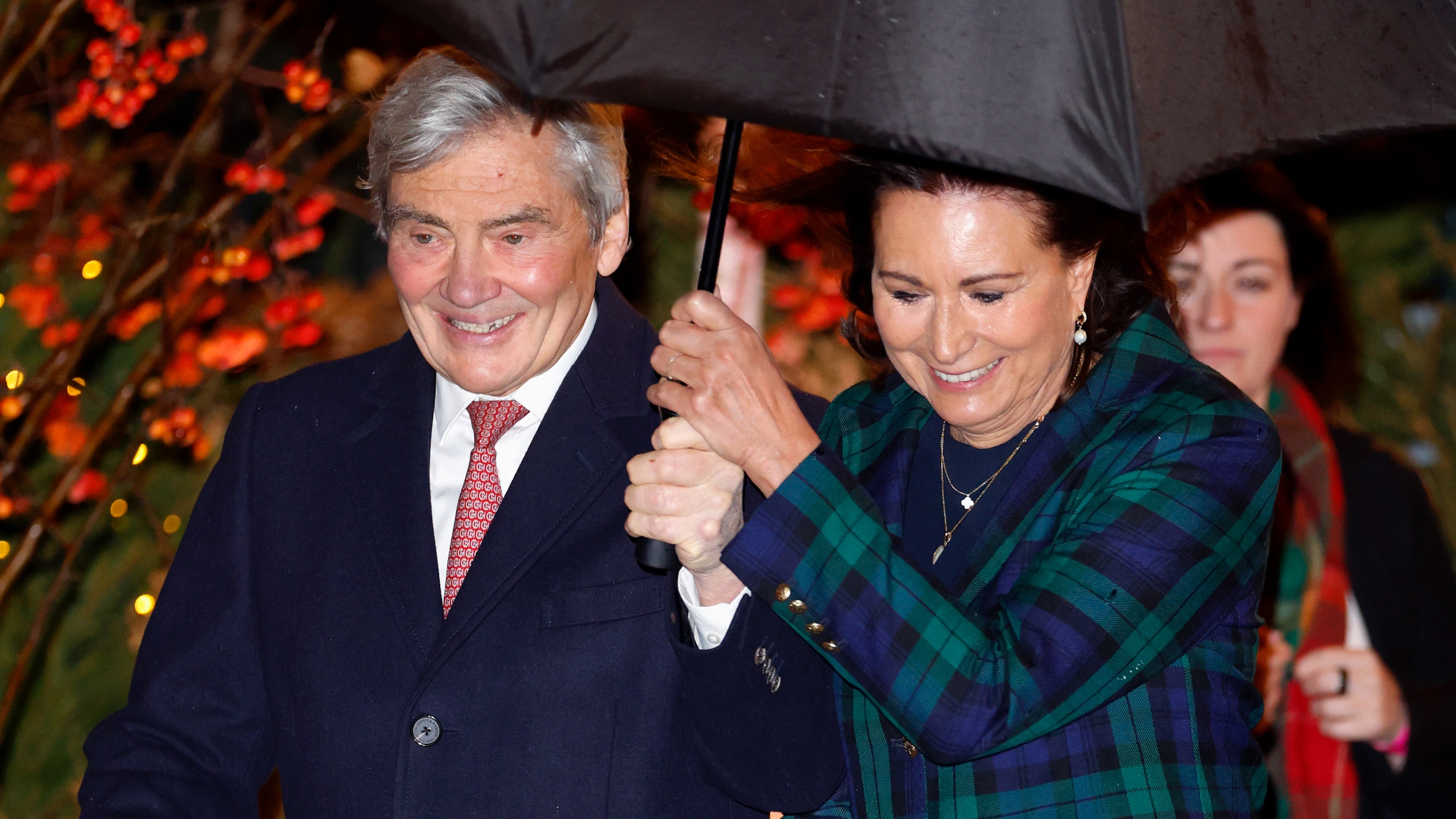 Michael Middleton and Carole Middleton hold on to an umbrella as they attend the 'Together At Christmas' Carol Service at Westminster Abbey on December 5, 2025