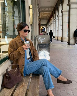 woman in suede jacket and jeans