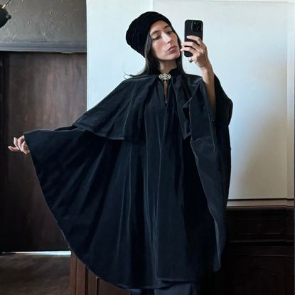 Alexis Badiyi wearing a cape