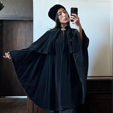 Alexis Badiyi wearing a cape