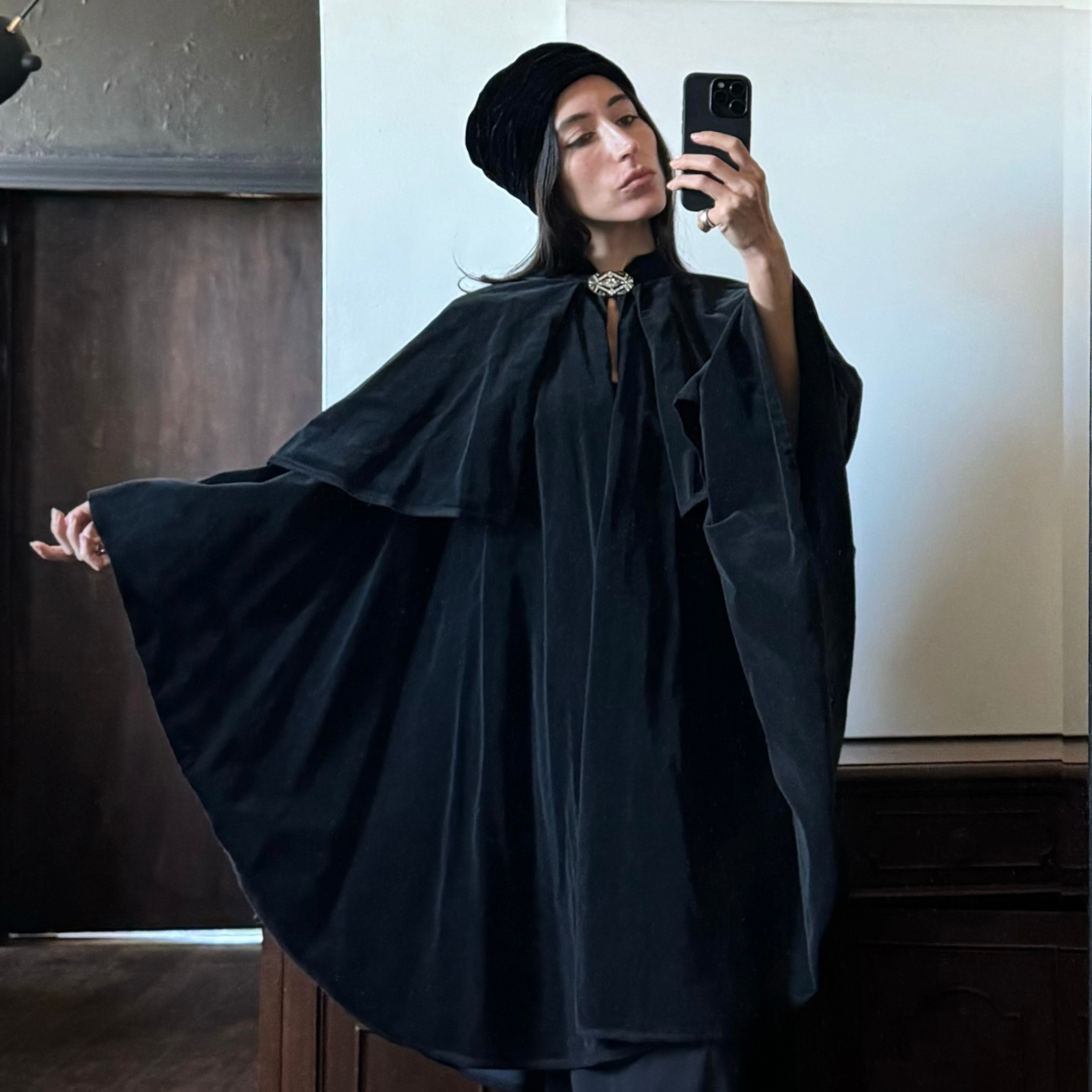 Alexis Badiyi wearing a cape