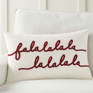 Falala Embroidered Lumbar Pillow against a white sofa.