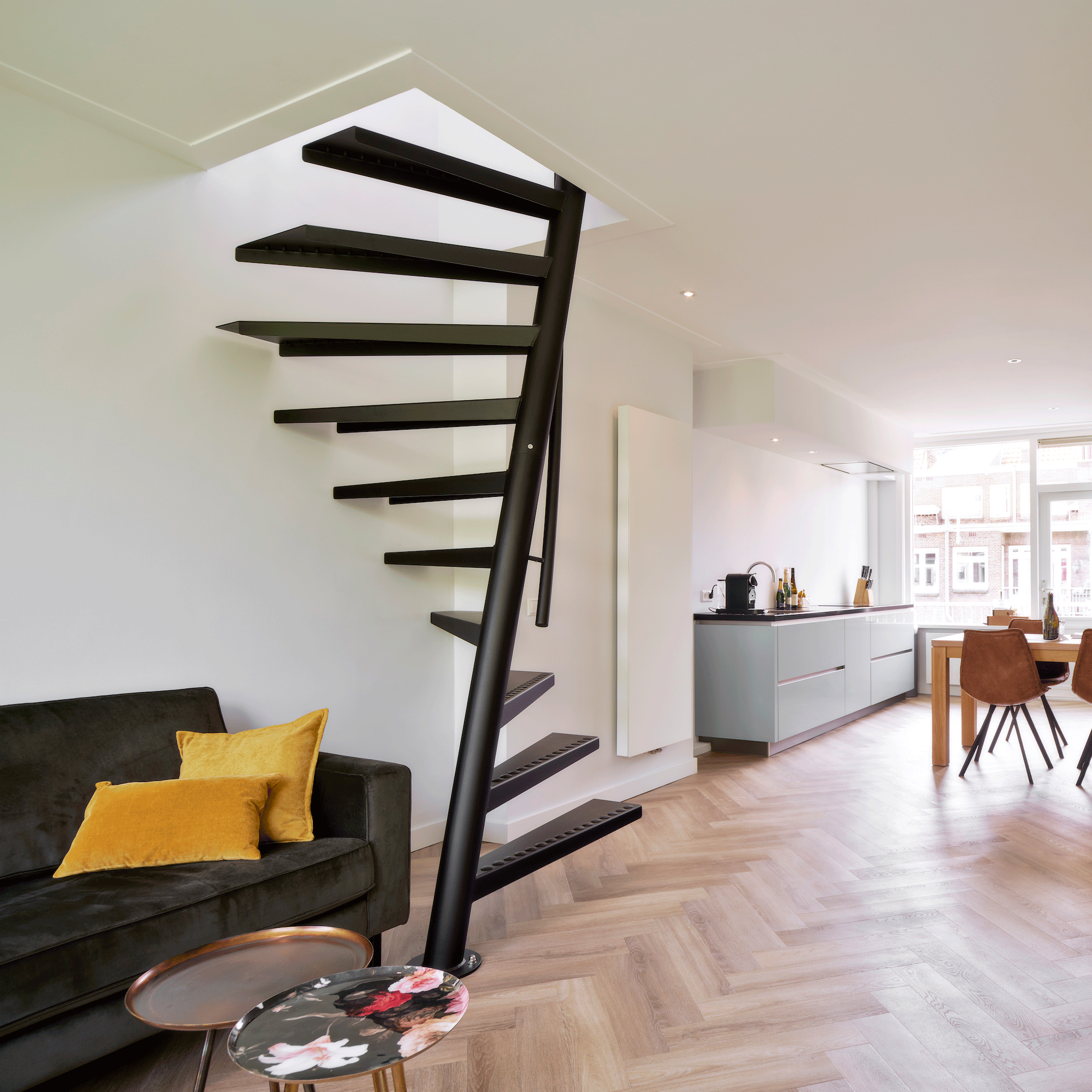 black spiral staircase in white room