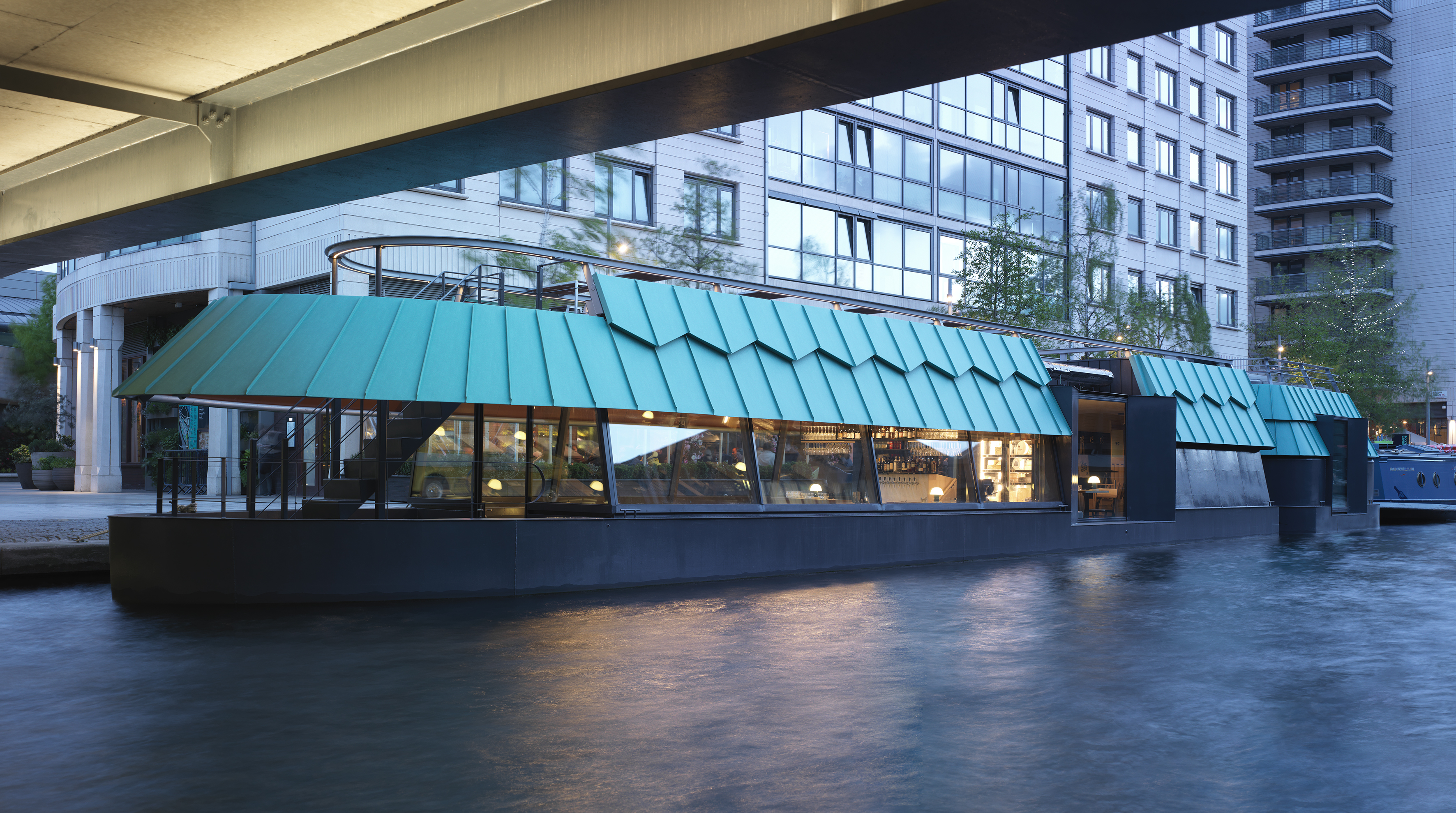 Cheese Barge restaurant opens on a canal in London, seen here at night