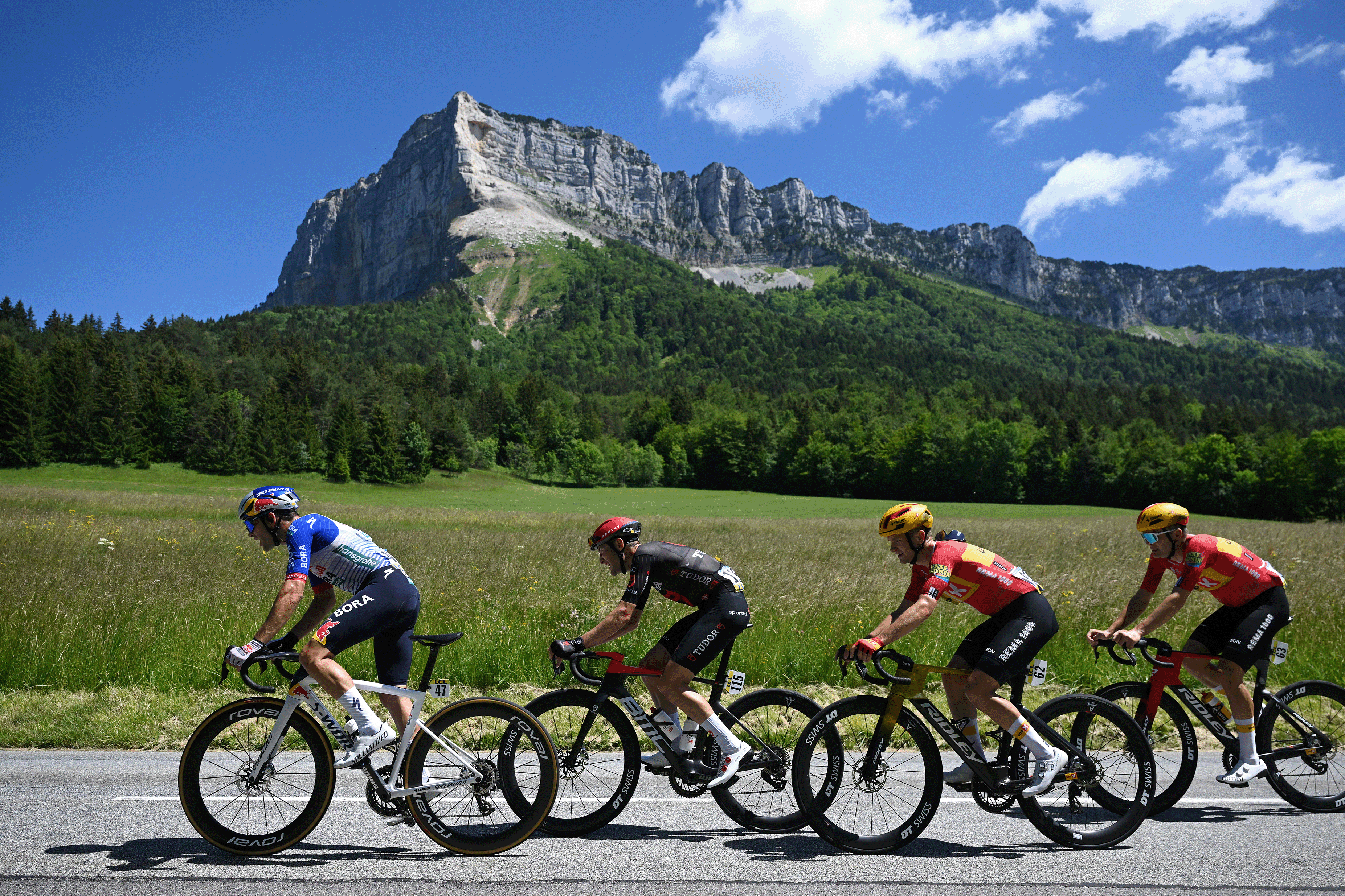 CREST-VOLAND, FRANCE - JUNE 12: (L-R) Gianni Vermeersch of Belgium and Team Red Bull - BORA - hansgrohe, Roland Thalmann of Switzerland and Team Tudor Pro Cycling, Martin Urianstad Bugge of Norway and Team Uno-X Mobility and a general view of the peloton competing during the 78th Tour Auvergne-Rhone-Alpes 2026, Stage 6 a 182.3km stage from Saint-Vulbas to Crest-Voland 1211m / #UCIWT / on June 12, 2026 in Crest-Voland, France. (Photo by Dario Belingheri/Getty Images)