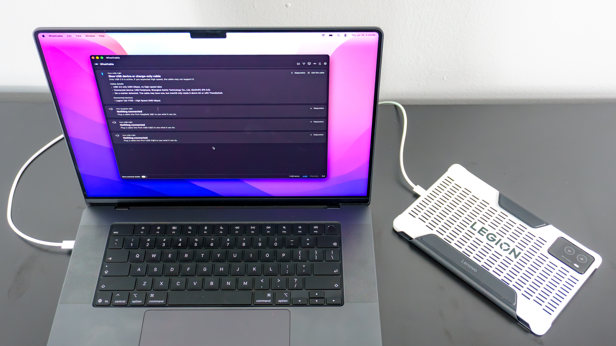 A MacBook Pro running the WhatCable app with a Lenovo Legion Tab 3 tablet connected to it