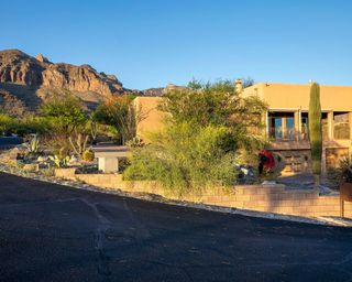 adobe house with desert landscaping and mountain backdrop in Tucson AZ