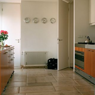 kitchen with wall clock and wooden cabinet