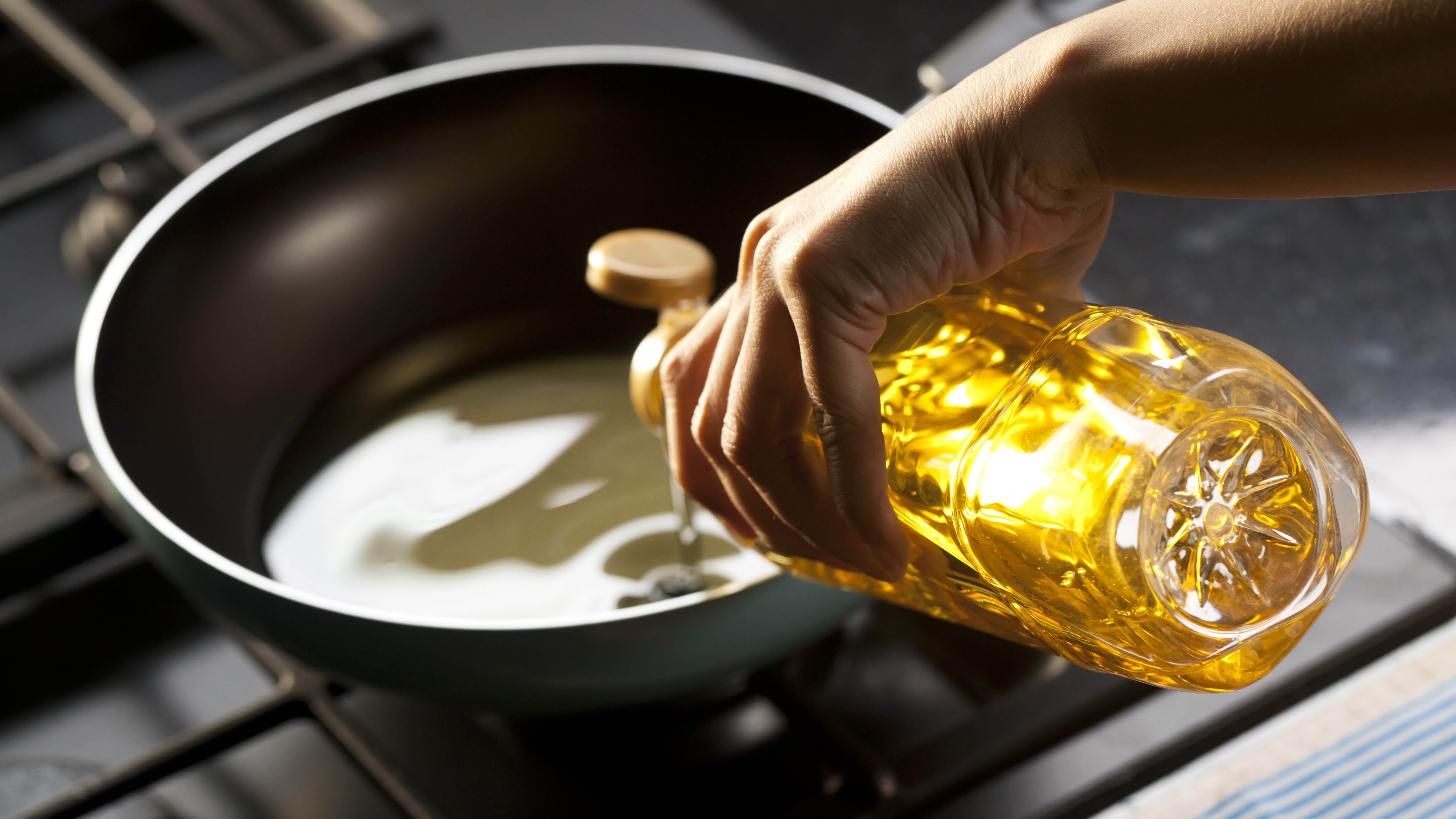 Pouring oil in a frying pan