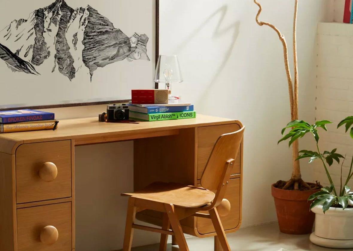 Ediana Washed Chenille Rug in home office space with wooden desk, chair, and house plant