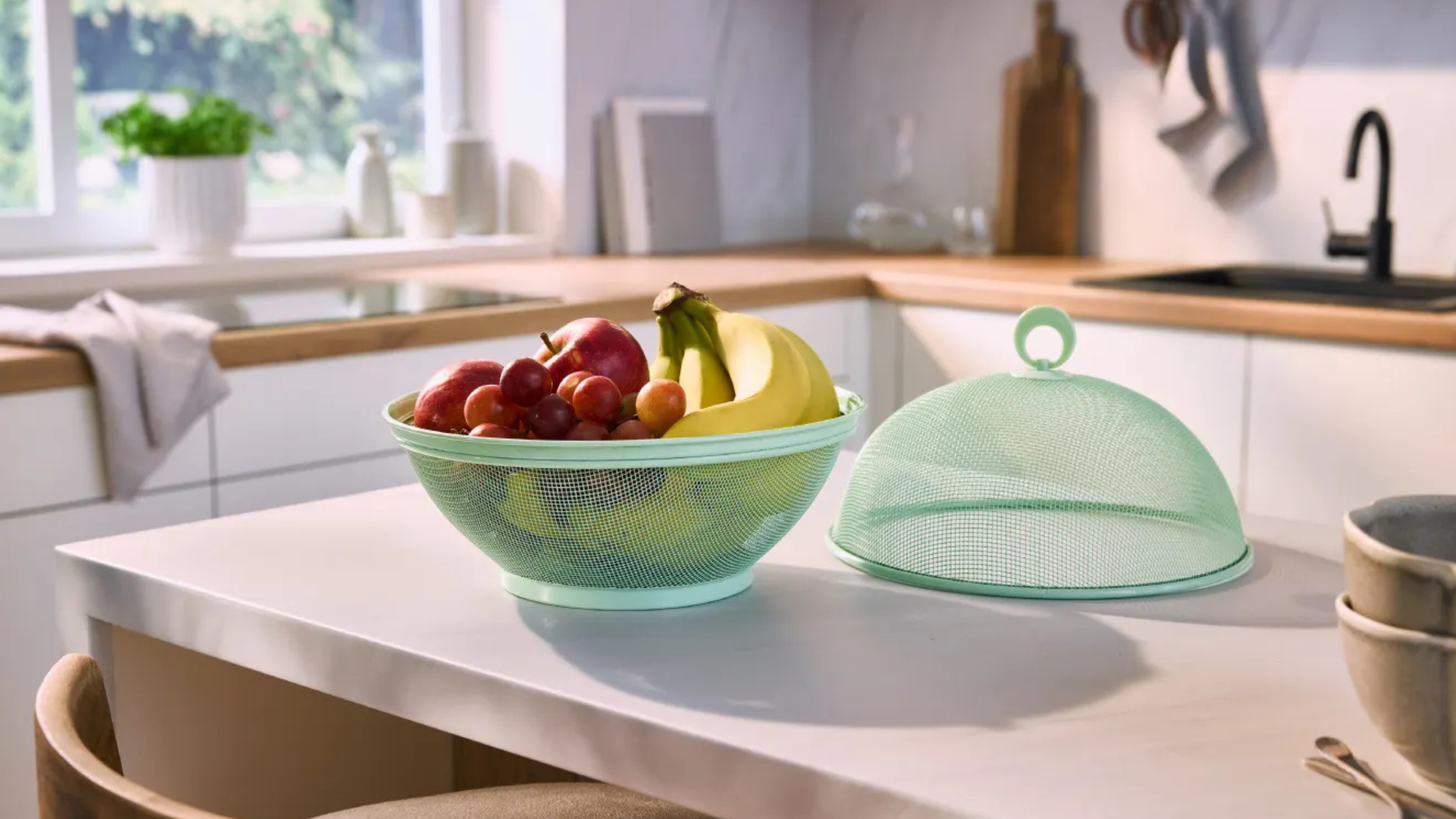 Lidl green metal mesh fruit bowl on kitchen island