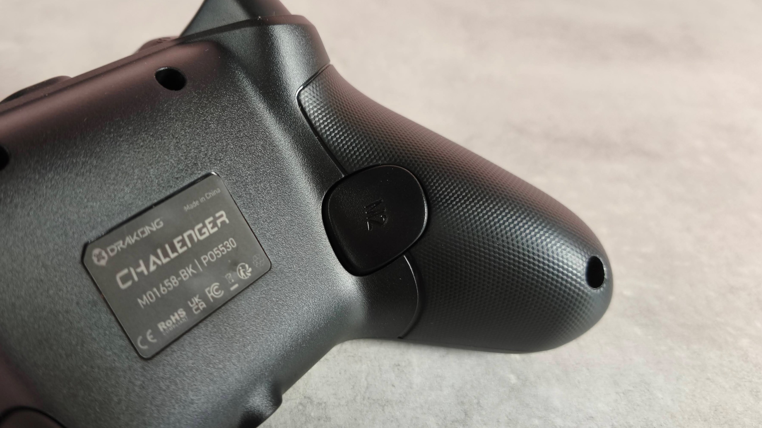 Close-up of back button on Drakong Challenger, on a desk