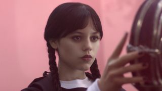 Jenna Ortega as Wednesday Addams in Netflix's Wednesday Episode 203 looking coldly at someone.