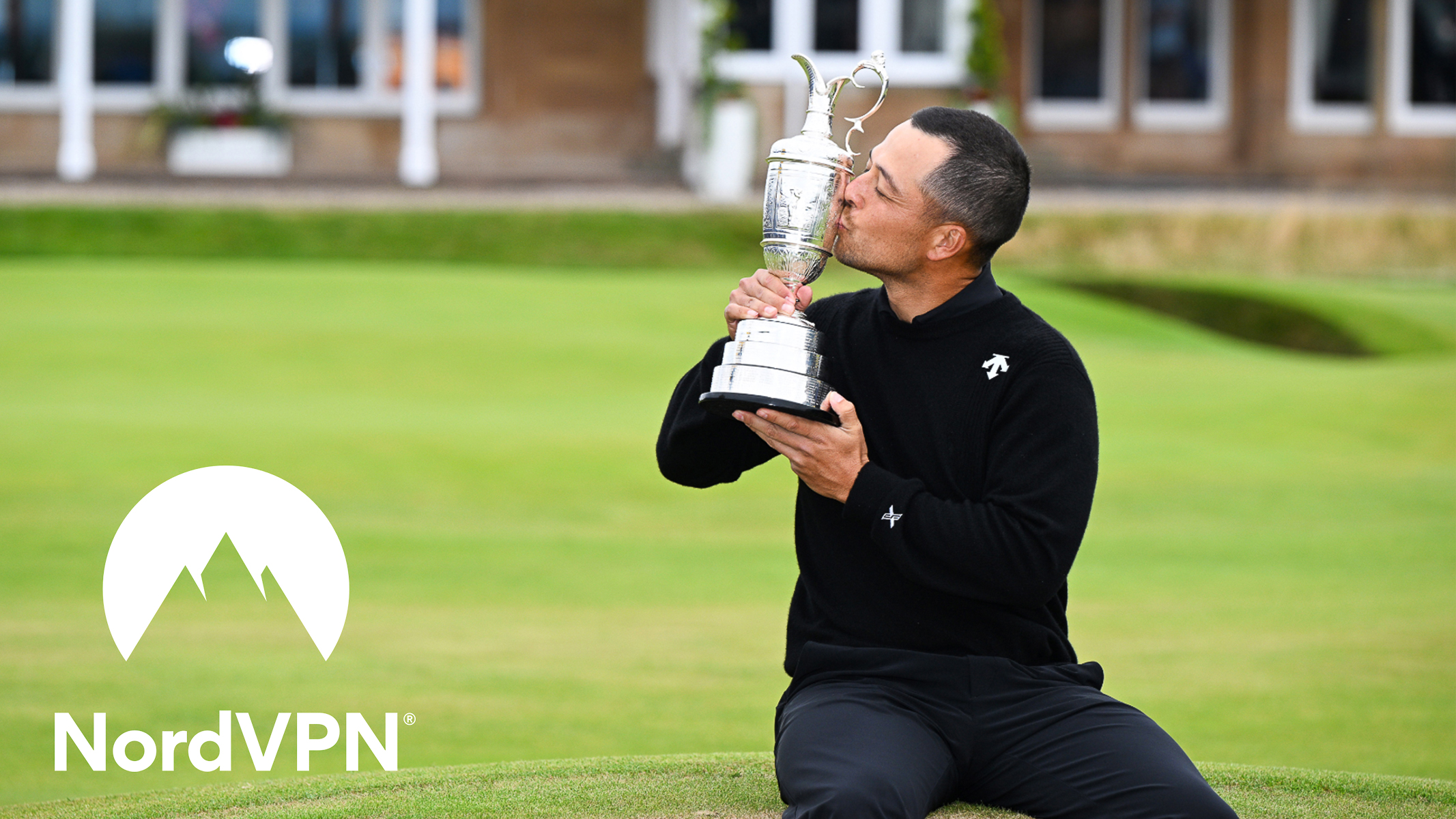 Xander Schauffele kisses the Claret Jug with NordVPN logo