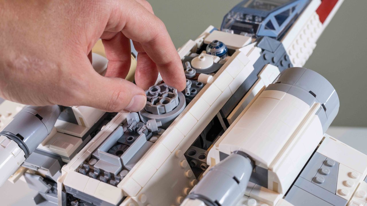 Lego UCS X-Wing Starfighter, hand operating the mechanism that opens the S-foils
